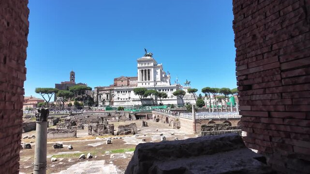 Ancient medieval stone window frame overlooking the Vittoriano in Rome