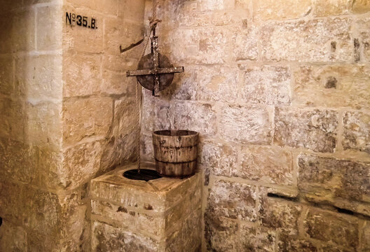 Well with a pulley block in Inquisitors Palace in historical part of Vittoriosa Birgu city in the Malta.