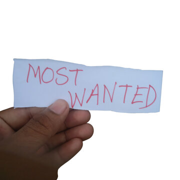 Hand holding paper sign with most wanted text written on it isolated on transparent background