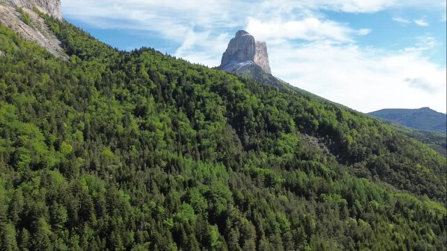 Drone aerial shot of a Mountain in Vercors, filmed in the Forest under Summer weather conditions. The Orbit, rotation captures the Majestic beauty of Scotland&rsquo;s natural landscape.
