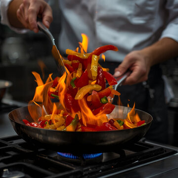 Chef Tossing Colorful Bell Peppers with Flames in a Professional Kitchen
