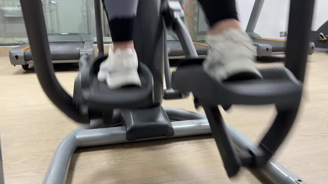 A person exercises on an elliptical machine to improve fitness and build strength. The steps show the workout process and movements.