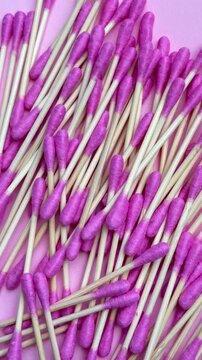 Bamboo cotton buds dropping to create a full frame background for hygiene concept