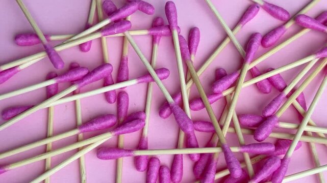 Bamboo cotton buds dropping to create a full frame background for hygiene concept
