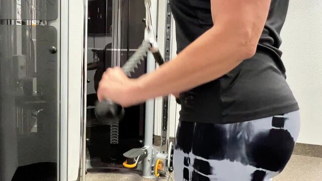 A person demonstrates various arm exercises using weights in a gym. The focus is on proper technique and movement.