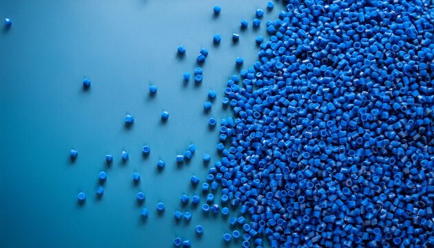 close up flat lay of a blue plastic polypropylene granules on a table copy space