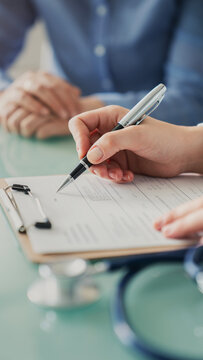 Doctor assisting patient with medical form