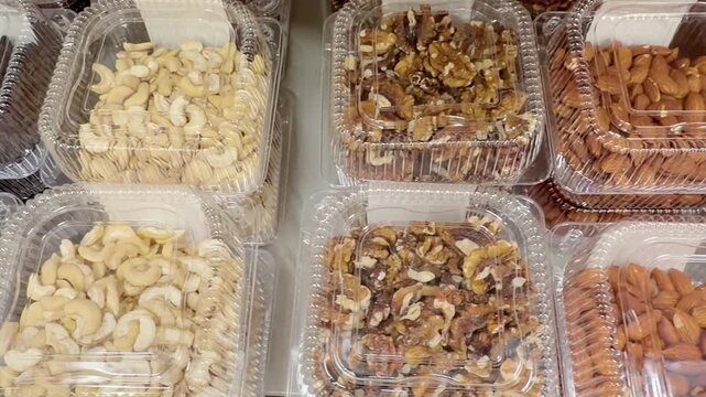 Variety of Packaged Nuts on Display in a Supermarket Aisle