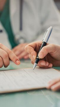 Doctor assisting patient with medical form
