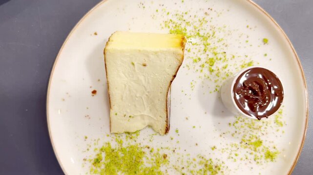 Cheesecake  San Sebasti&aacute;n   with   Chocolate Sauce Topping Served on a White Plate