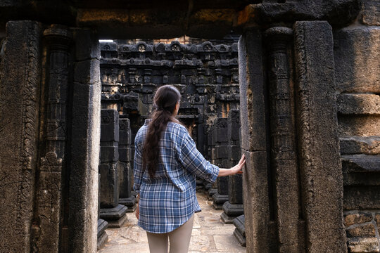 Female traveler exploring the ancient Nalanda Gedige temple in Sri Lanka. Historic stone architecture, Buddhist heritage, cultural tourism, and archaeological travel destination.