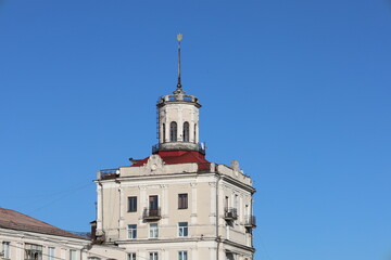Fototapeta premium The top of a building against a blue sky