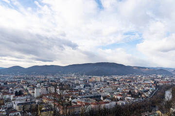 Fototapeta premium City Skyline with Hills Under Dramatic Cloudy Sky Panorama