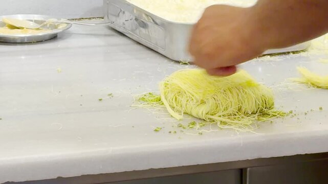 Cooking Process &ndash; Frying Traditional Turkish Kadayıf Pastry in a Large Skillet on a Stove Top.Frying Kadayıf on the Stove &ndash; Turkish Dessert Preparation