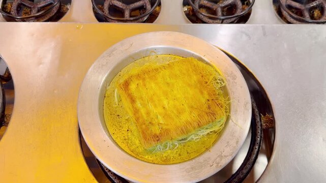 Cooking Process &ndash; Frying Traditional Turkish Kadayıf Pastry in a Large Skillet on a Stove Top.Frying Kadayıf on the Stove &ndash; Turkish Dessert Preparation
