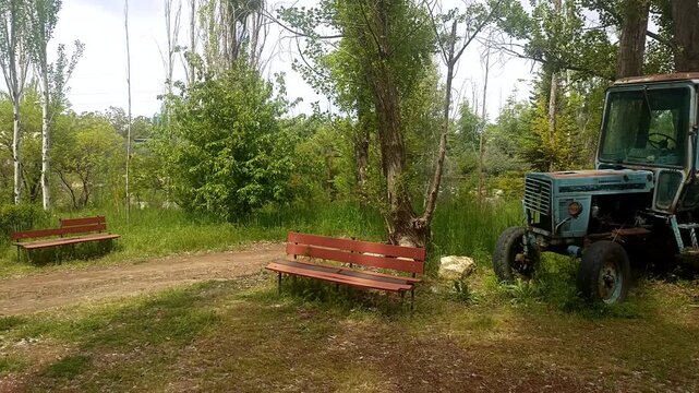 Abandoned old rusty tractor in the forest