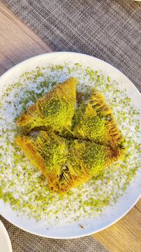 Traditional Turkish Dessert Platter with Kadayıf and Dondurma Ice Cream on a Rustic Table