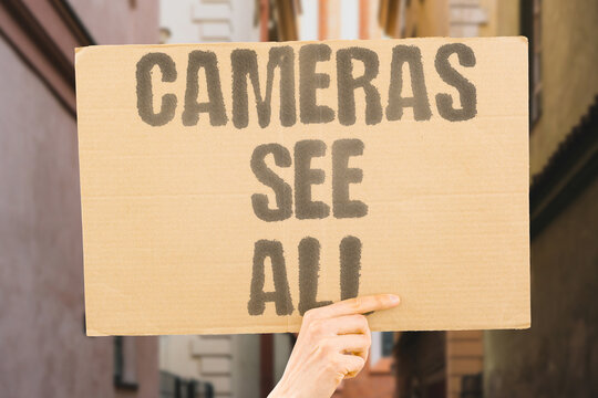"Cameras see all" Surveillance covers every public corner. COVERS, CORNER, SURVEILLANCE, CAMERAS, ALL.