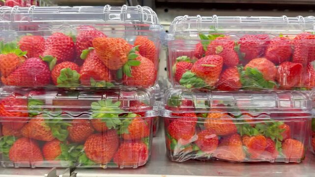 Shelf with Various Packaged Berries &ndash; Strawberries, Blueberries, and Raspberries in Plastic Containers in a Supermarket