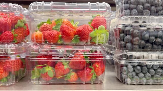 Shelf with Various Packaged Berries &ndash; Strawberries, Blueberries, and Raspberries in Plastic Containers in a Supermarket