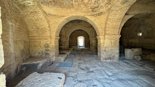 Ancient Underground Stone Cellar and Crypt Interior with Medieval Brick Arches Vaulted Ceiling and Historical Ruins in Spain
