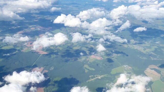 View of White Clouds from an Airplane Window During a Flight at High Altitude