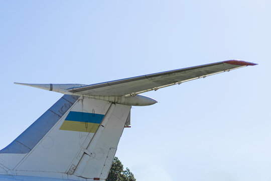 Tail Fin of Cargo Plane with Ukrainian Flag Against Blue Sky