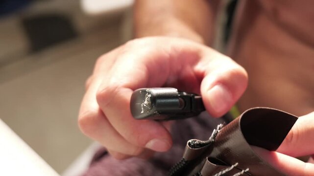 Person melting synthetic fiber threads with lighter