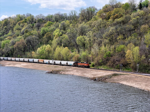 Railroad locomotive pulling a freight train along the back waters of the Mississippi river