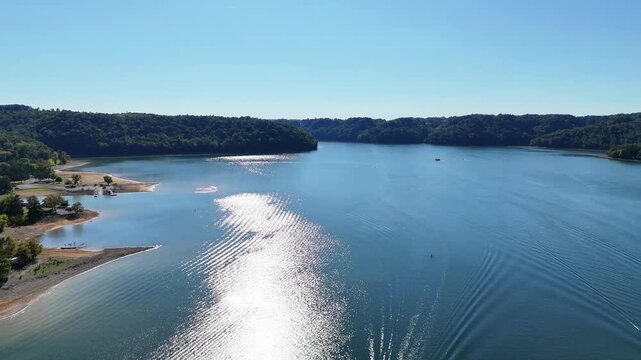 Aerial View of Sunset Marina & Resort and Highway 111 Bridge on Dale Hollow Lake, Monroe, Tennessee - Scenic Waterfront with Boat Slips, Forested Shoreline, and Clear Blue Water