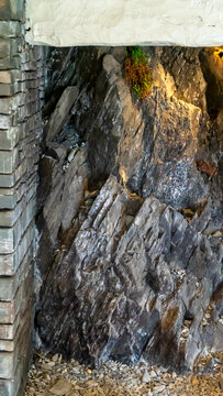 Metamorphic or sedimentary rock with distinct layering, dip of the layers, and fractures