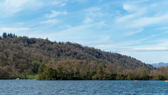 Lake Windermere in the Lake District National Park, where one of the picturesque, small, wooded islands sits in the center
