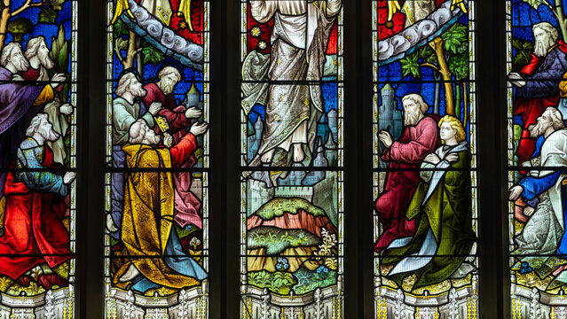 A traditional stained-glass window depicting the Ascension of Jesus Christ, divided into five sections (lights) featuring figures of Christ, angels, and the apostles