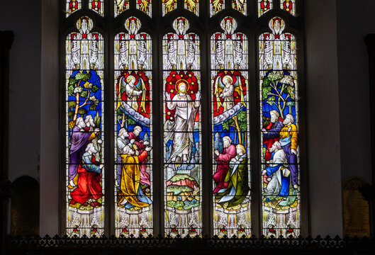 A traditional stained-glass window depicting the Ascension of Jesus Christ, divided into five sections (lights) featuring figures of Christ, angels, and the apostles