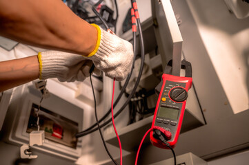 Close up unrecognized electrician in safety gloves upgrading home electric system for EV charging point © Jack Tamrong