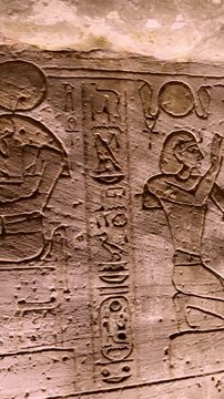 Ancient Egyptian wall paintings with detailed hieroglyphs and ritual scenes inside the Abu Simbel Temple, revealing sacred art, mythology, and preserved history. Egypt.