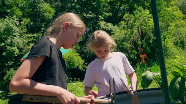 Two children crafting in the garden, symbolizing the value of hands-on creativity in a digital world.