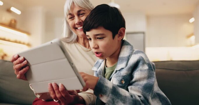 Grandmother, kid and tablet in home for learning, play game and bonding together on weekend. Tech, smile and boy with grandparent on sofa for educational gaming, scroll app and online development
