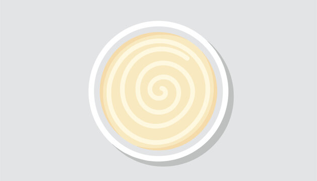 High angle view of a simple white ceramic bowl filled with creamy yellow yogurt or delicious pureed vegetable soup.