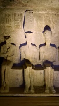 Ancient Egyptian wall statues with detailed hieroglyphs and ritual scenes inside the Abu Simbel Temple, revealing sacred art, mythology, and preserved history. Egypt.