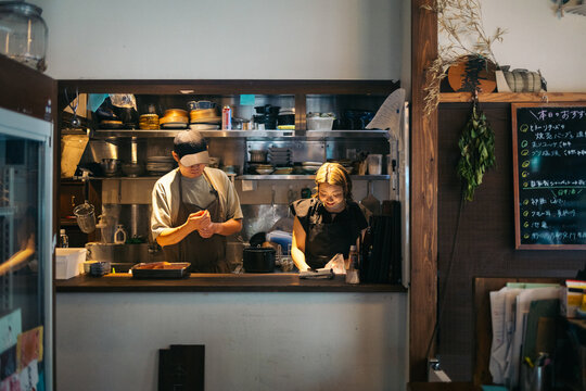 Cooks preparing Japanese food in a calm kitchen