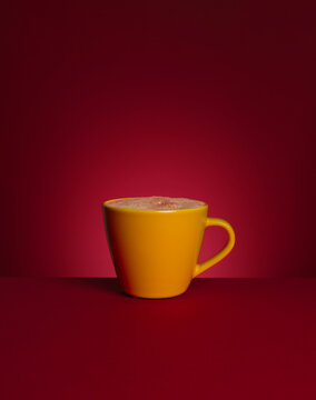 A cup of hot chocolate  against red