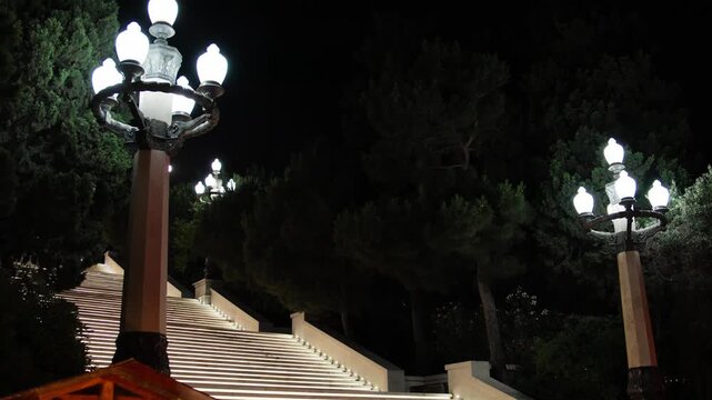 Illuminated Outdoor Stairs with Lamp Posts at Night