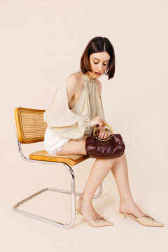 Wosing holding elegant leather handbag