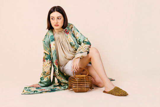 Woman wearing floral robe with bamboo bag