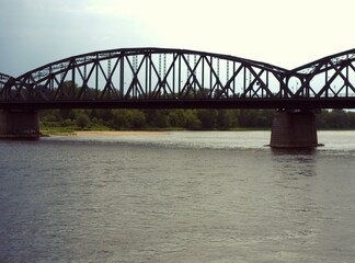 Naklejka premium Steel truss arch bridge over a wide river
