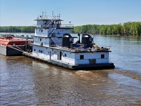 Tug boat pushing a set liquid cargo barges South down the Mississippi River