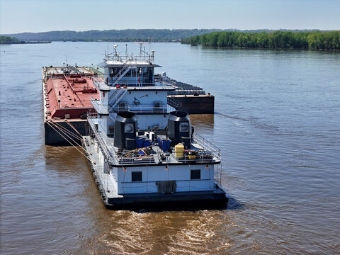 Tug boat pushing a set liquid cargo barges South down the Mississippi River
