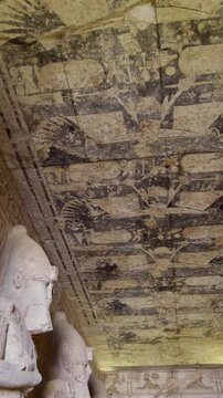 Ancient Egyptian chamber with statues and decorated ceiling inside the Abu Simbel Temple, showcasing sacred architecture, carvings, and timeless spiritual symbolism. Egypt.