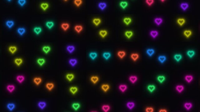 Colorful neon hearts on dark background in random arrangement